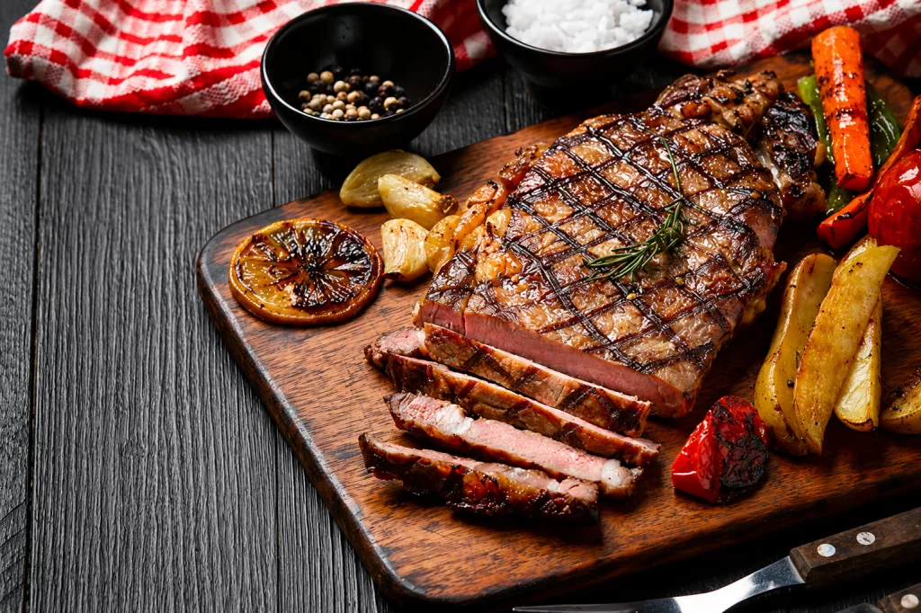 A perfectly seared, highly marbled Wagyu Akaushi full-blood steak cut and served at a luxury Houston restaurant